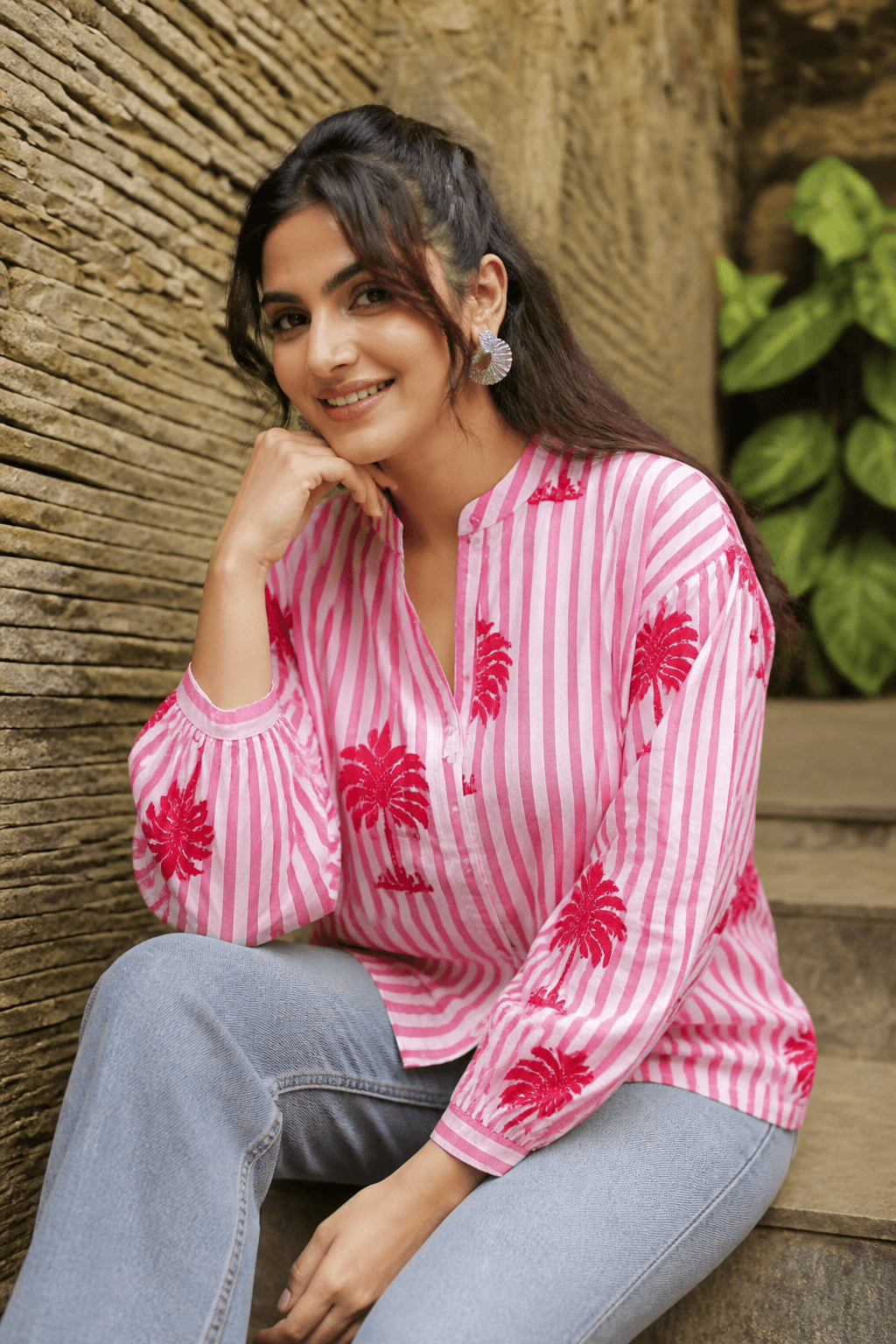 Young Indian woman in pink palm-print striped cotton shirt